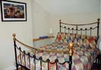 Bedroom 1 - Victorian styled brass double bed with duvet and pillows. Pine wardrobe, dressing table - hair dryer
