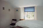 Bedroom 2 - Two single beds with duvets and pillows. Wardrobe formed in alcove and pine storage cupboard.