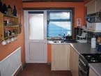 Well equipped kitchen with gas cooker, fridge, washing machine, microwave, electric kettle and toaster.