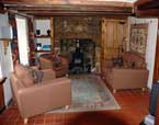 Lounge - Seating area, with restored granite fire place housing an Electric Stove with realistic flame effect. TV with BluRay/DVD player, mini HiFi unit with CD and telephone for both incoming and out going calls.